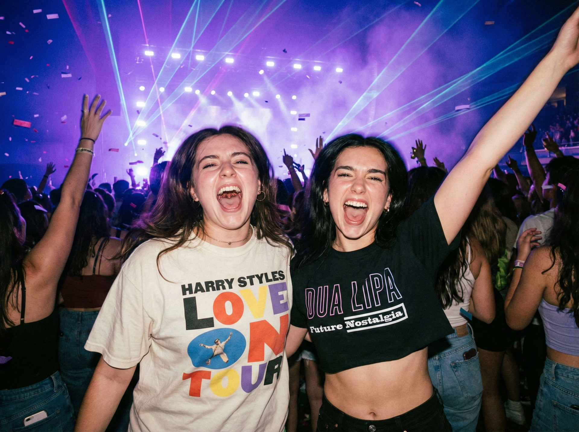 Two friends wearing matching concert hoodies at music event